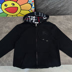 Black hooded zip jacket with plaid-lined hood and front pockets