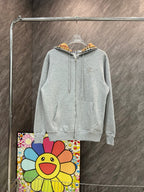 Light gray zip-up hoodie with drawstring hood and small Burberry horse logo