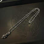 Chrome accessories silver-tone chain bracelet with floral detail on dark box