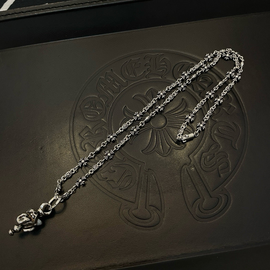 Chrome accessories silver-tone chain bracelet with floral detail on dark box