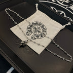 Chrome accessories silver-tone chain necklace laid on drawstring pouch