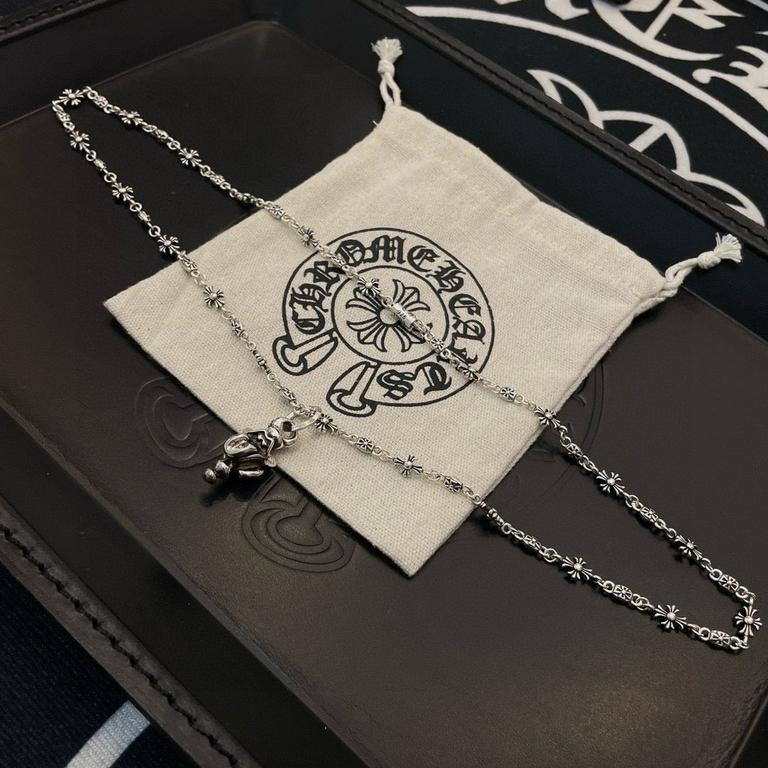 Chrome accessories silver-tone chain necklace laid on drawstring pouch