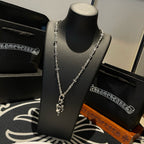 Chrome accessories silver-tone chain necklace with center pendant on display bust