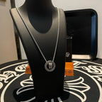 Chrome Accessories necklace with round pendant and silver chain on bust display, front view.