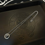 Chrome Accessories pendant necklace with round medallion on textured black leather case.