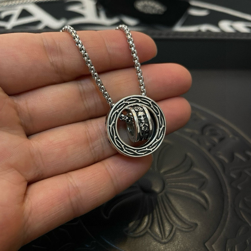 Chrome Accessories round pendant necklace held in hand on palm, silver chain.