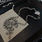 Silver cross pendant necklace plus matching chain bracelet on dark box