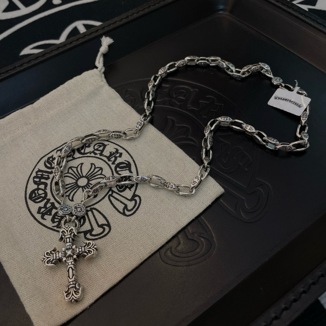 Silver cross pendant necklace plus matching chain bracelet on dark box