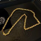 Gold tone chain necklace in a black box, U-shaped arrangement of rectangular links