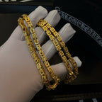 Gold tone chain necklace pair shown on white gloves, rectangular link segments
