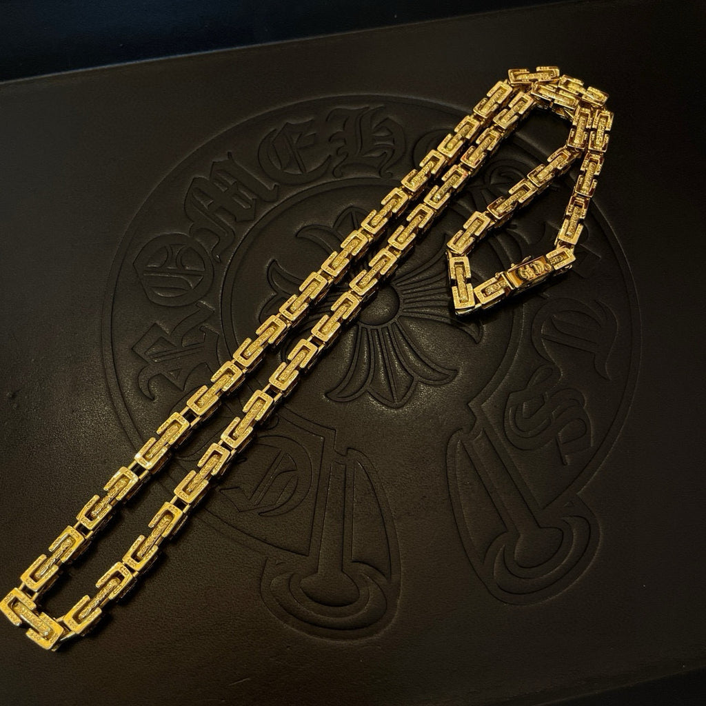 Gold tone chain necklace on a black box, long rectangular link pattern