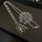 Silver-tone chain necklaces with cross pendants on black case