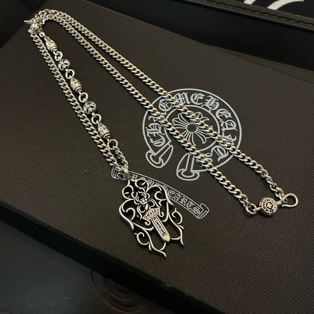 Silver-tone chain necklaces with cross pendants on black case