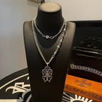 Silver-tone chain necklace with round charm and cross pendant