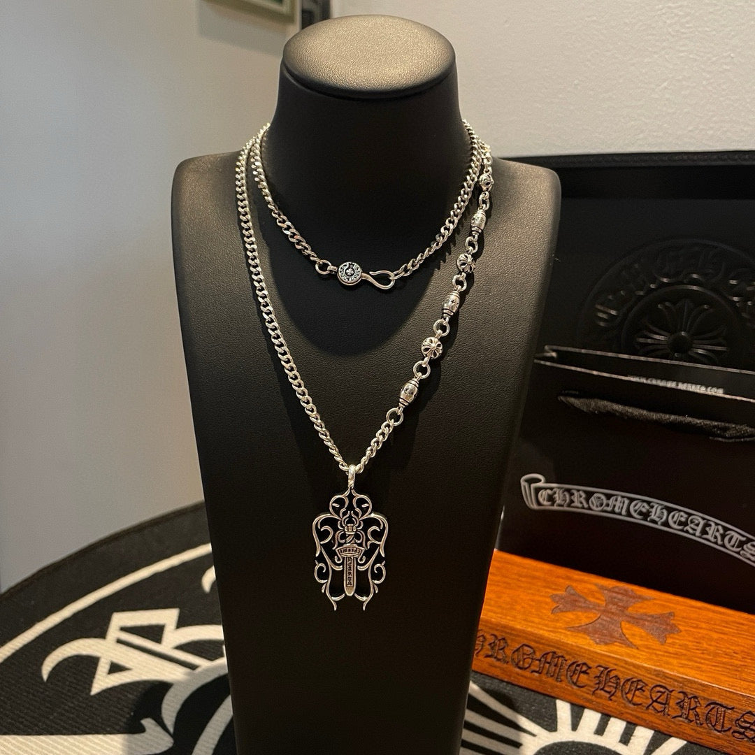 Silver-tone chain necklace with round charm and cross pendant