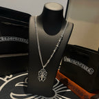 Silver-tone chain necklace with charm links and cross pendant