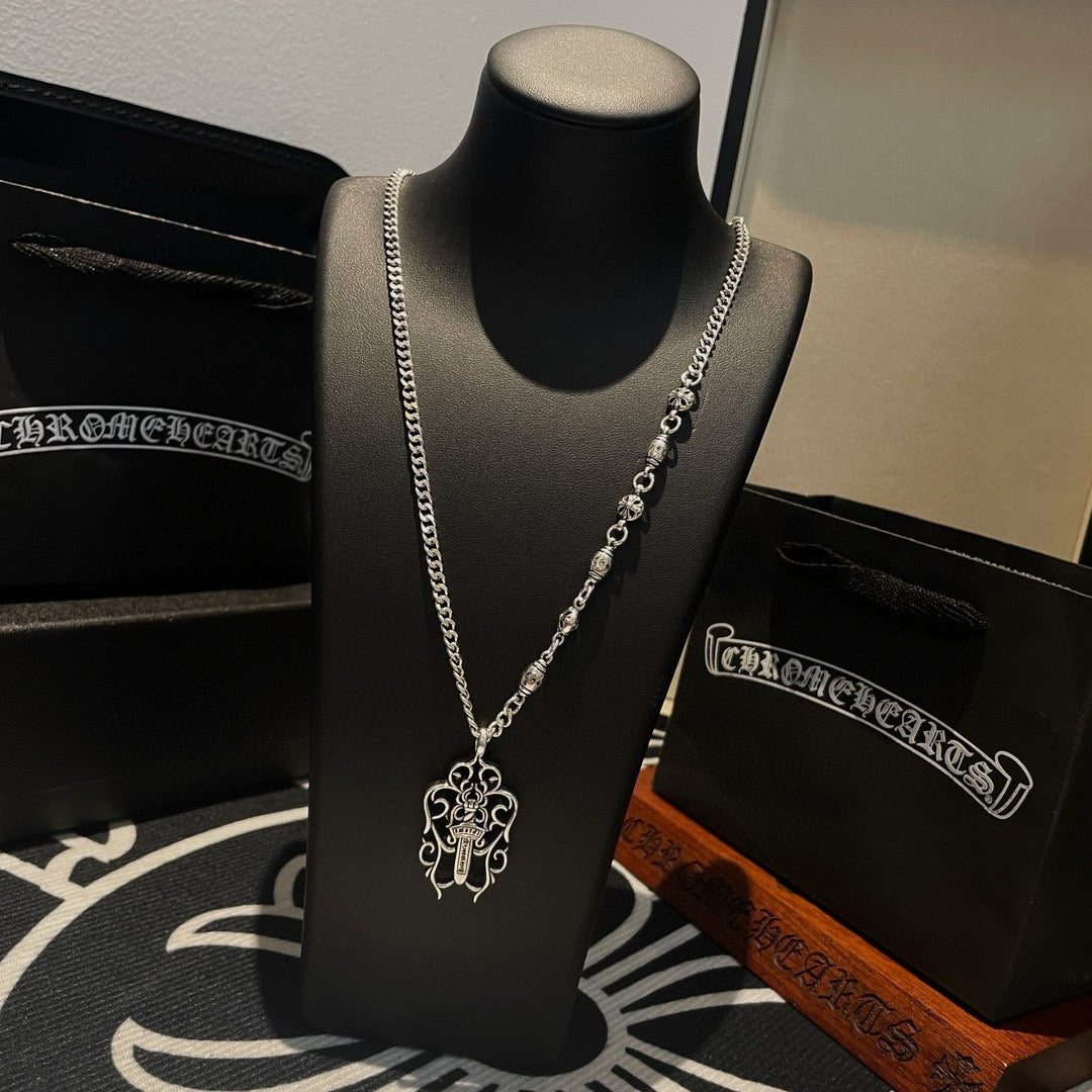 Silver-tone chain necklace with charm links and cross pendant