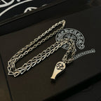 Silver-tone chain necklace set with charm pendants, on black case