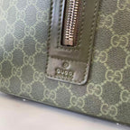 Gucci bag strap section with zipper pull and embossed Gucci logo, gray-green canvas