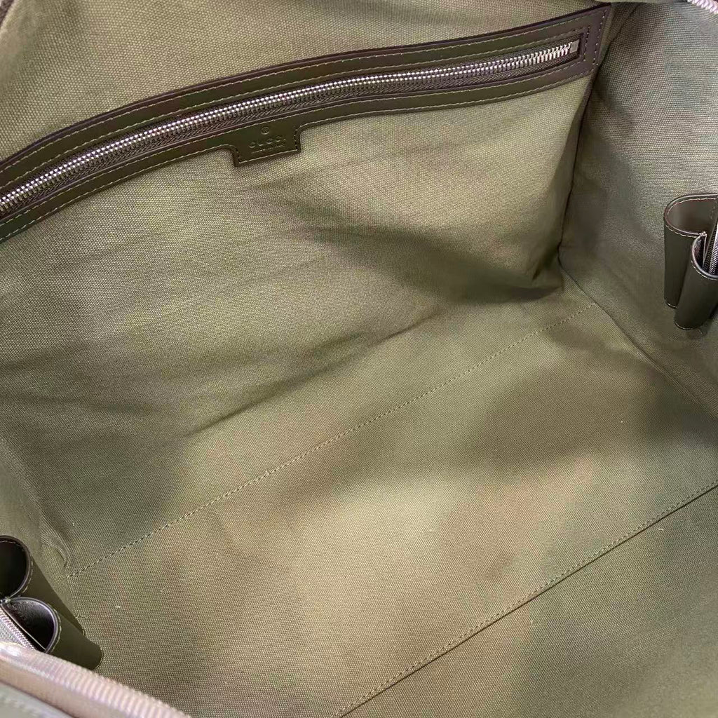 Gucci bag interior lining with stitched pocket panel and metal zipper pull