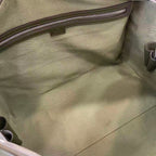 Gucci bag interior lining with stitched pocket panel and metal zipper pull