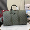 Gucci duffel bag in dark green GG canvas with top handles and front buckle detail