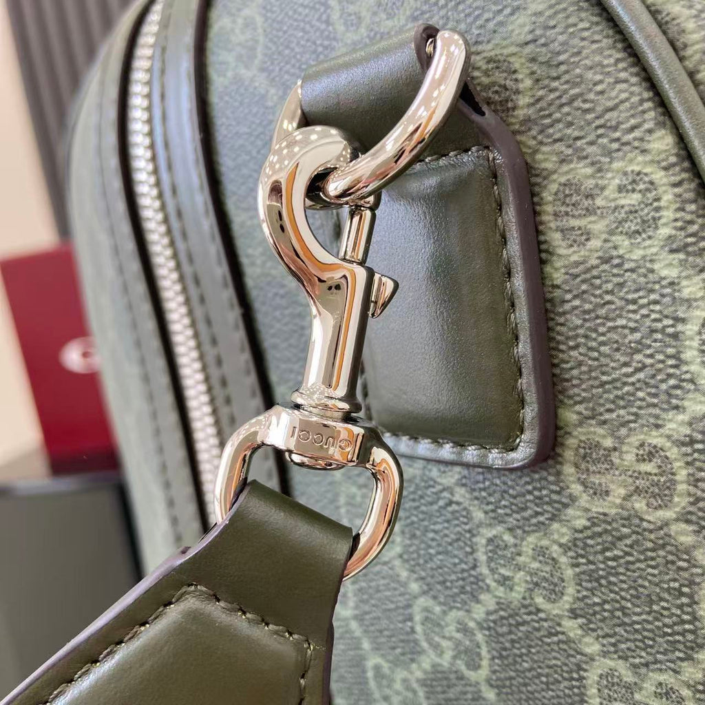 Gucci bag clasp hardware and handle loop on gray-green canvas