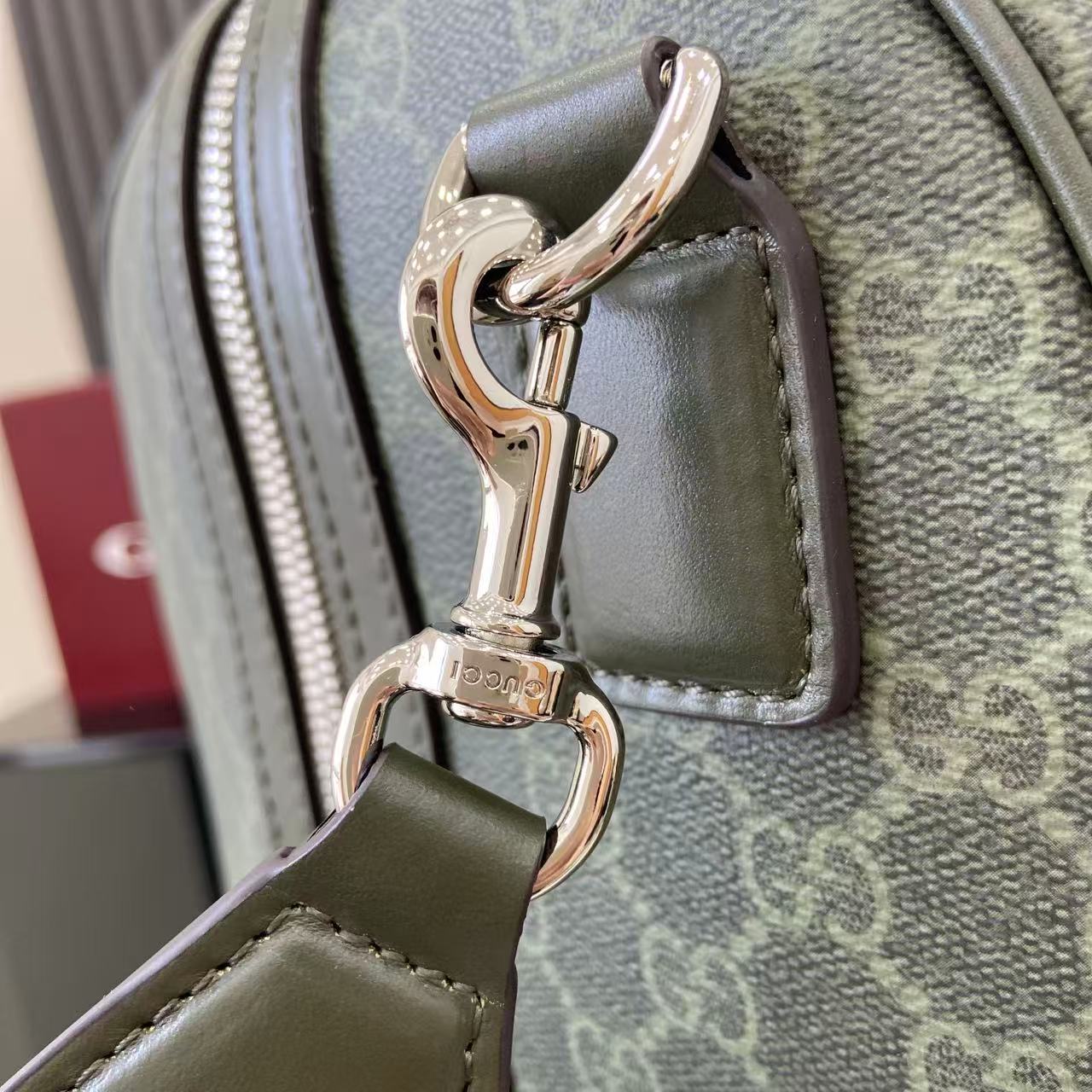 Gucci bag clasp hardware and handle loop on gray-green canvas