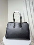 Black leather tote bag front view with silver buckle and stitched details