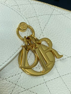 Gold logo charm clasp on white quilted leather bag