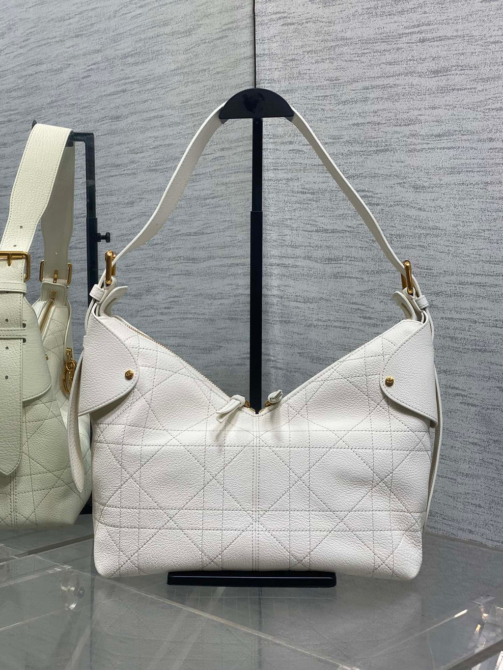 White quilted leather hobo bag with gold-tone hardware and shoulder strap