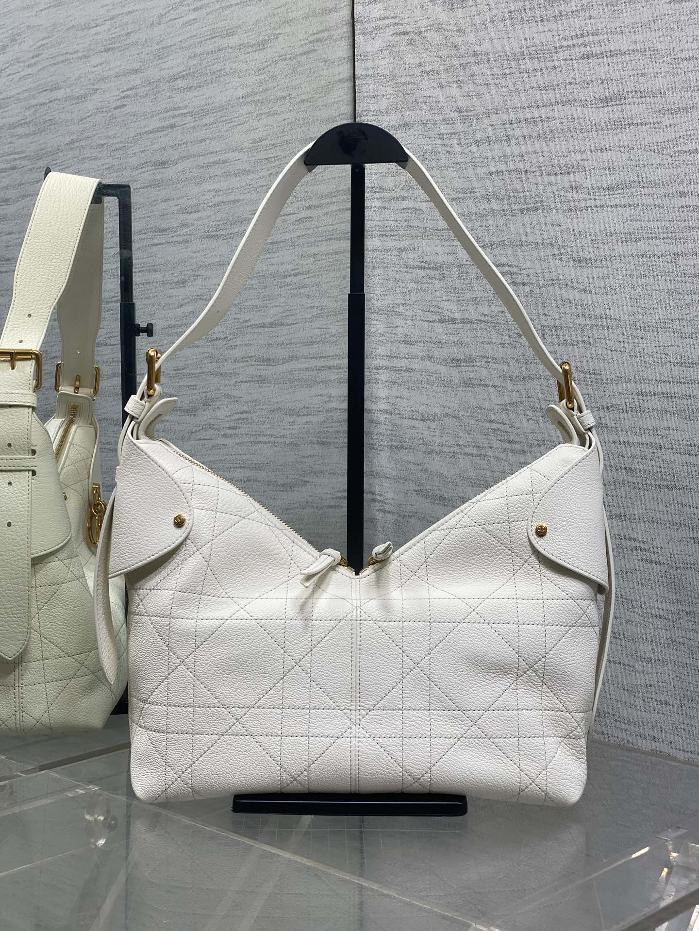 White quilted leather hobo bag with gold-tone hardware and shoulder strap