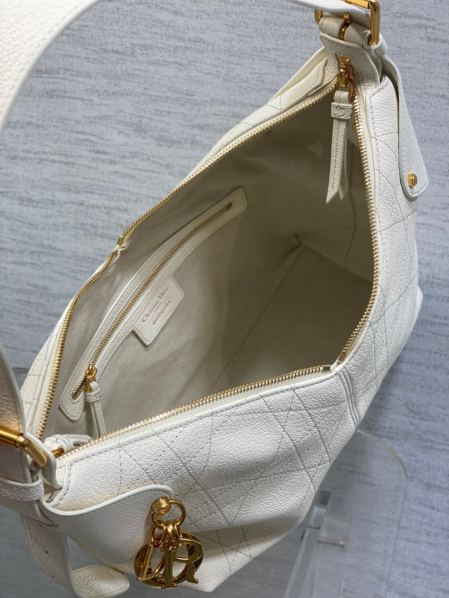 Dior white leather bag interior with zip pocket and gold chain pull