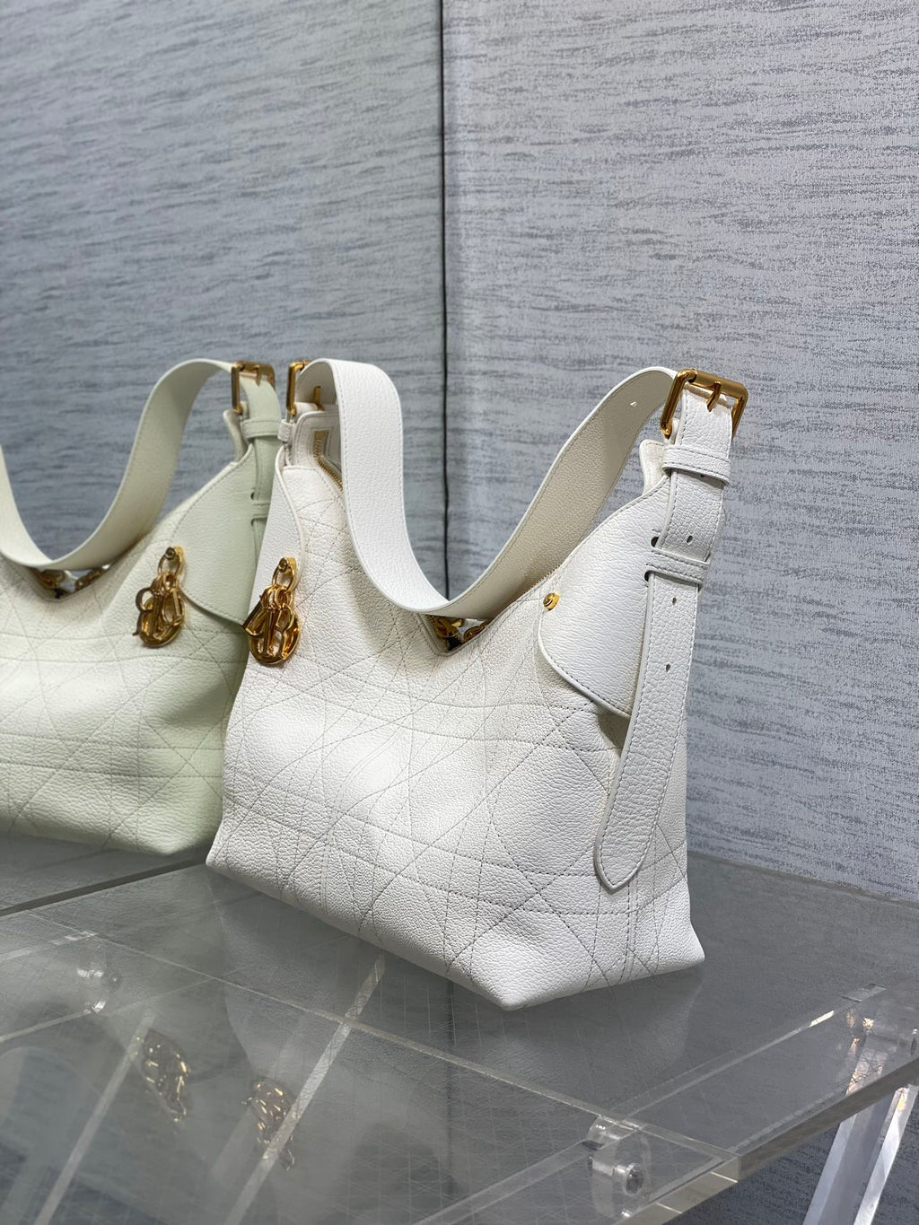 Dior white quilted leather shoulder bag with gold hardware and adjustable strap