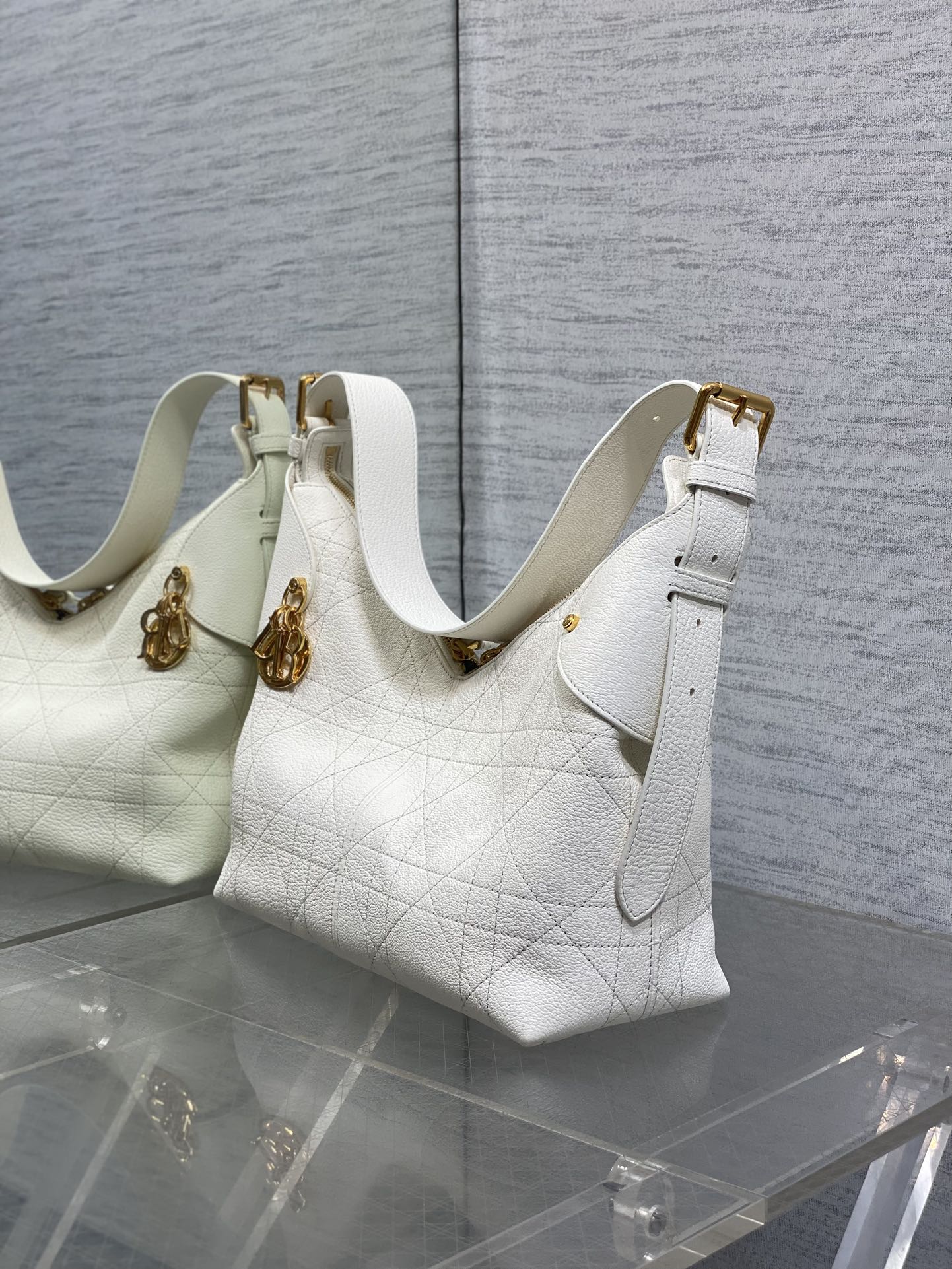 Dior white quilted leather shoulder bag with gold hardware and adjustable strap