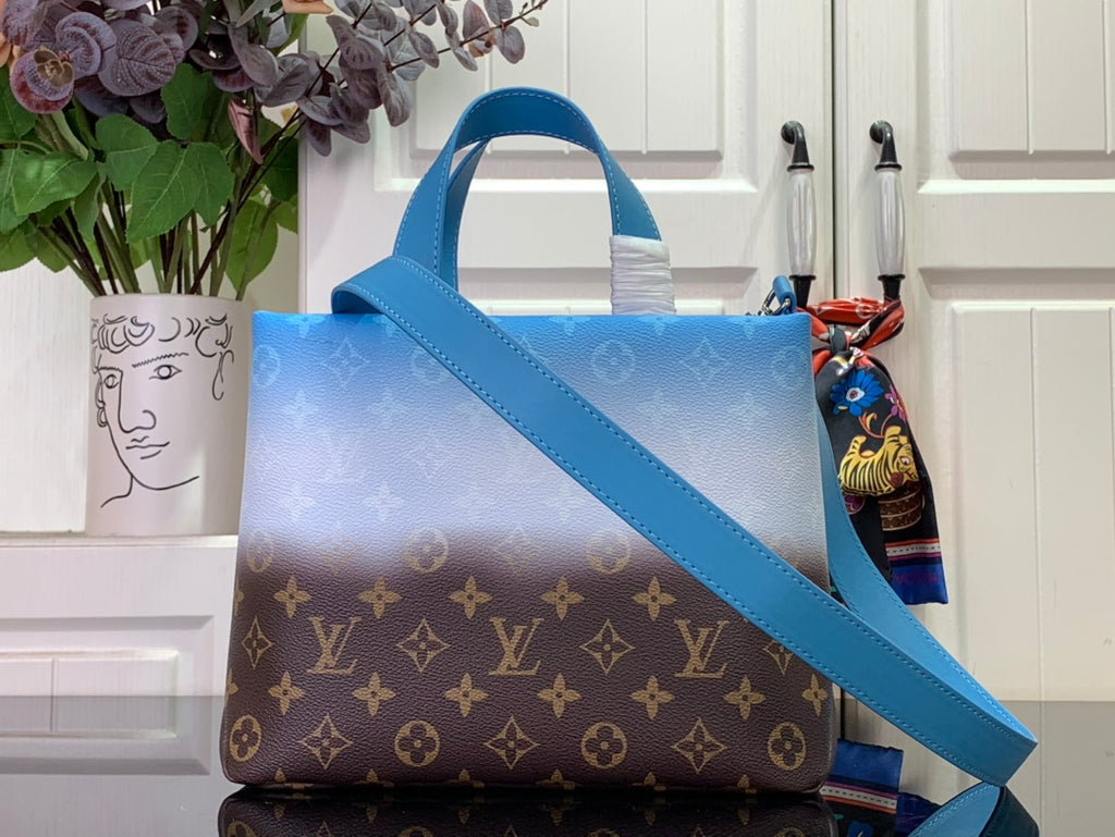 Blue and brown monogram handbag with diagonal shoulder strap and top handle