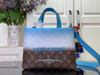 Blue and brown monogram handbag with top handles and shoulder strap, front view