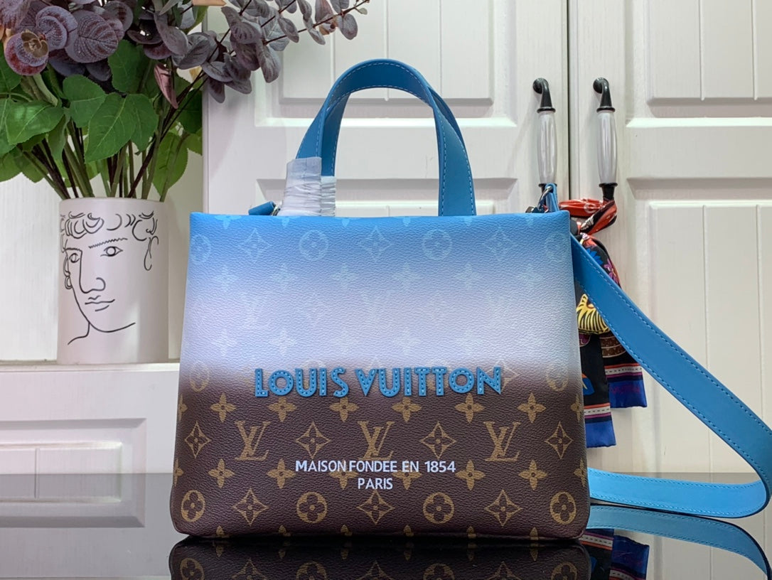 Blue and brown monogram handbag with top handles and shoulder strap, front view