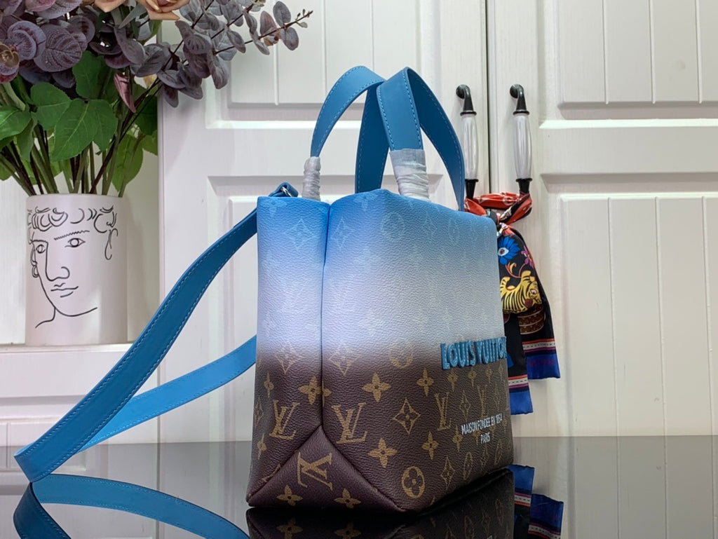 Blue and brown monogram handbag with side view and long shoulder strap