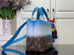 Blue and brown monogram handbag with side view and long shoulder strap