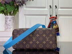 Blue and brown monogram handbag with crossbody strap and top handle, side view