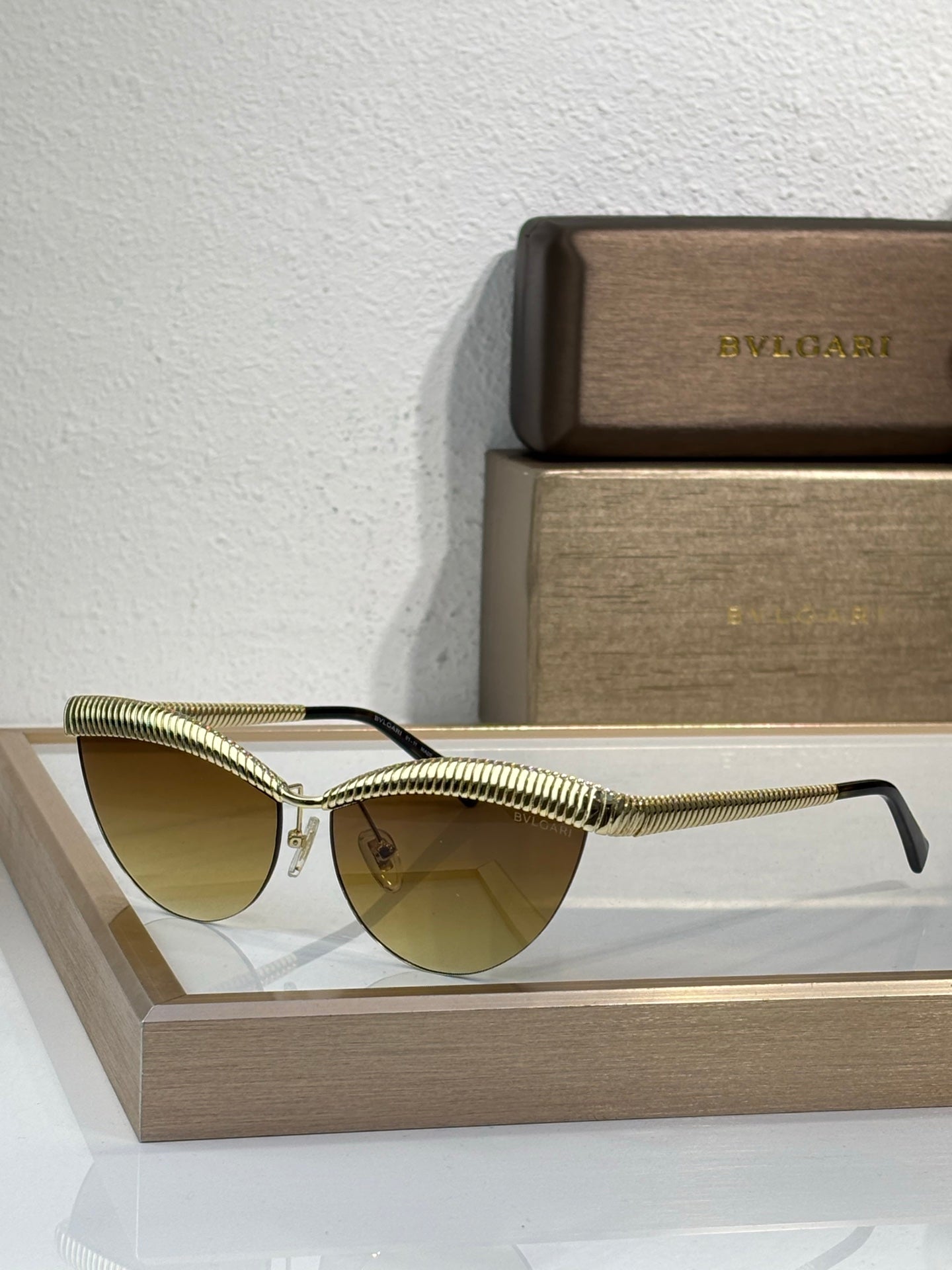 Bvlgari sunglasses with gold wireframe and amber-tinted round lenses
