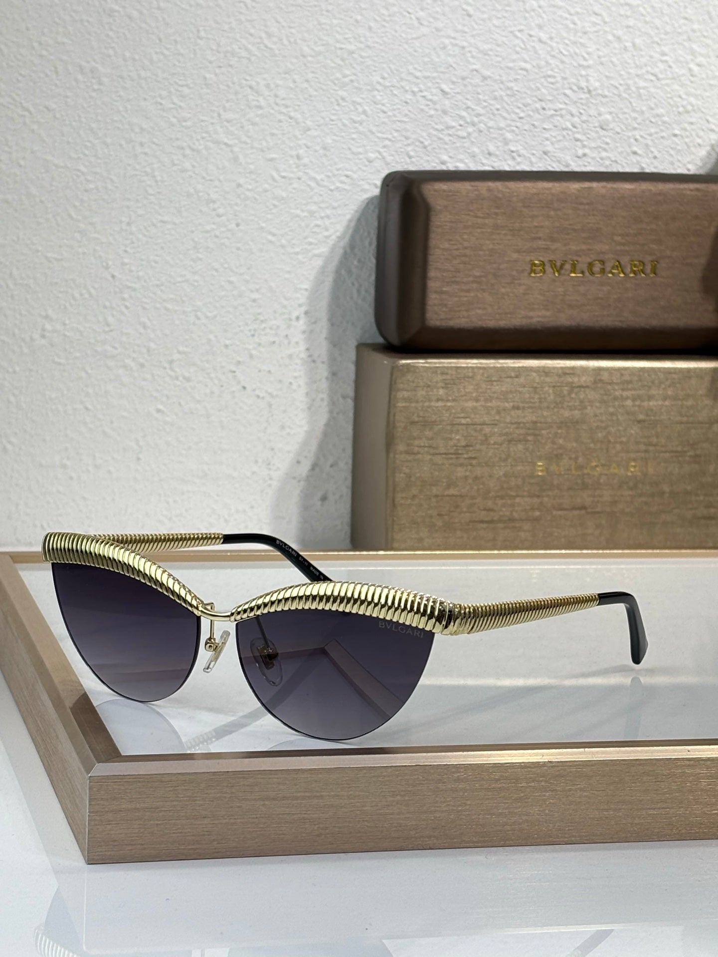 Bvlgari sunglasses with gold wireframe and dark tinted round lenses