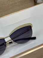Bvlgari sunglasses side view with dark tinted round lens and gold frame detail