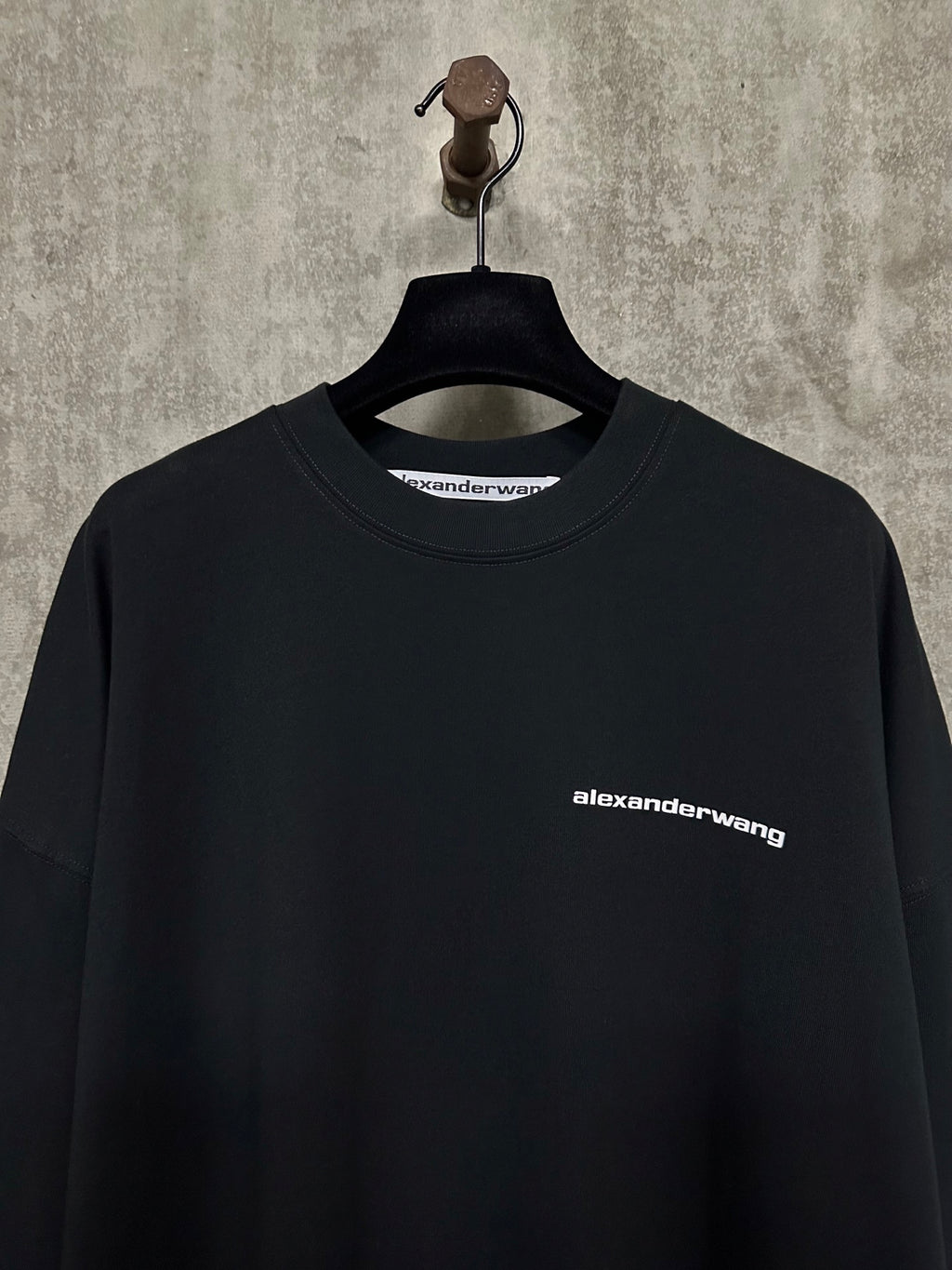 Black long-sleeve crewneck shirt with alexanderwang logo at chest