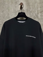 Black long-sleeve crewneck shirt with alexanderwang logo at chest
