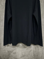 Black long-sleeve crewneck shirt, back view with lower hem