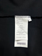 Clothing care label on black long-sleeve shirt, size M