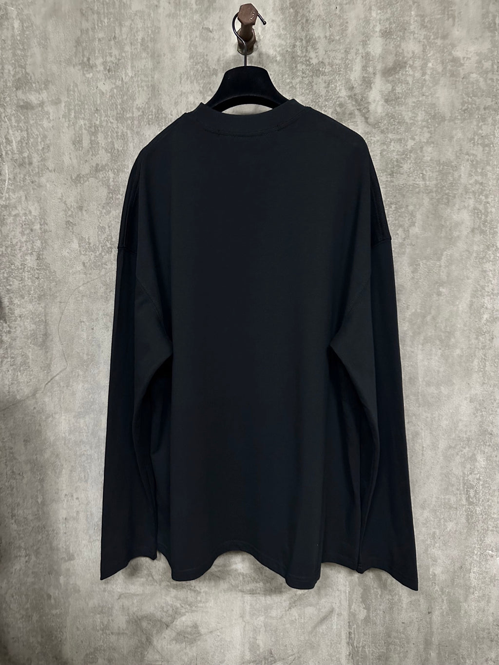 Black long-sleeve crewneck shirt, back view