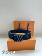 Leather belt with dark monogram print and large metal buckle, on box
